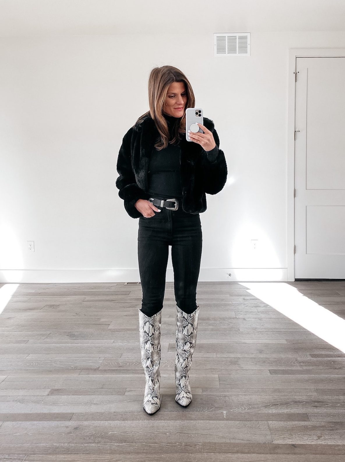 all black winter outfit idea with snakeskin tall boots, winter date night outfit idea