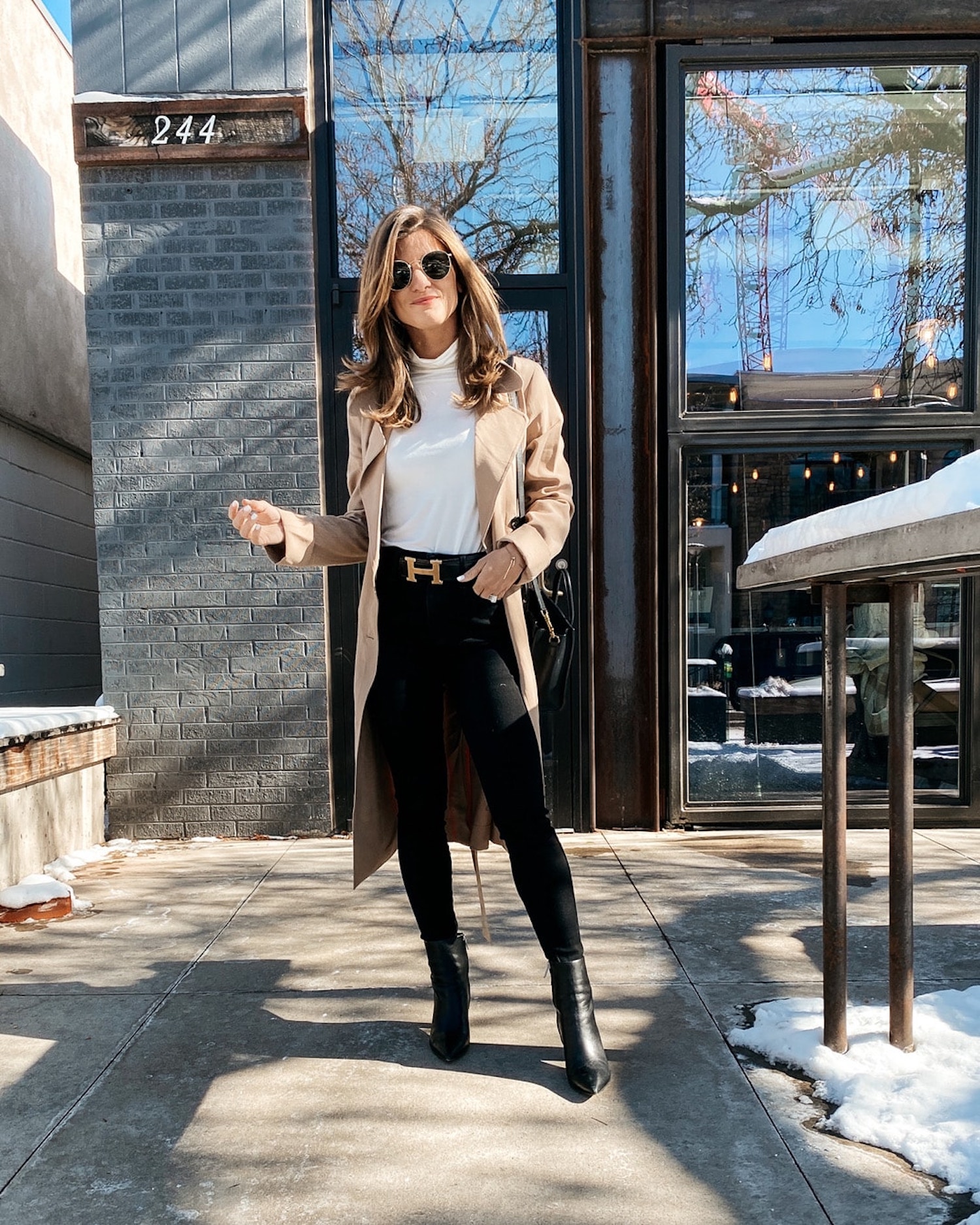 winter outfit idea business casual, white turtleneck, black booties, Hermes belt, camel trench coat