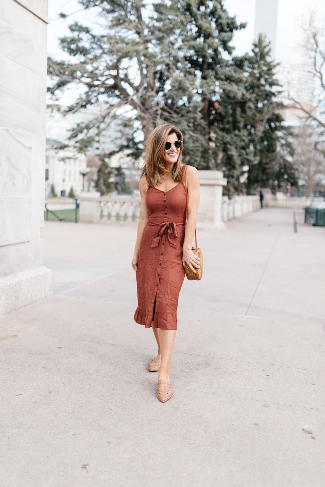 Brighton Keller wearing rust dress, brown mules and woven purse