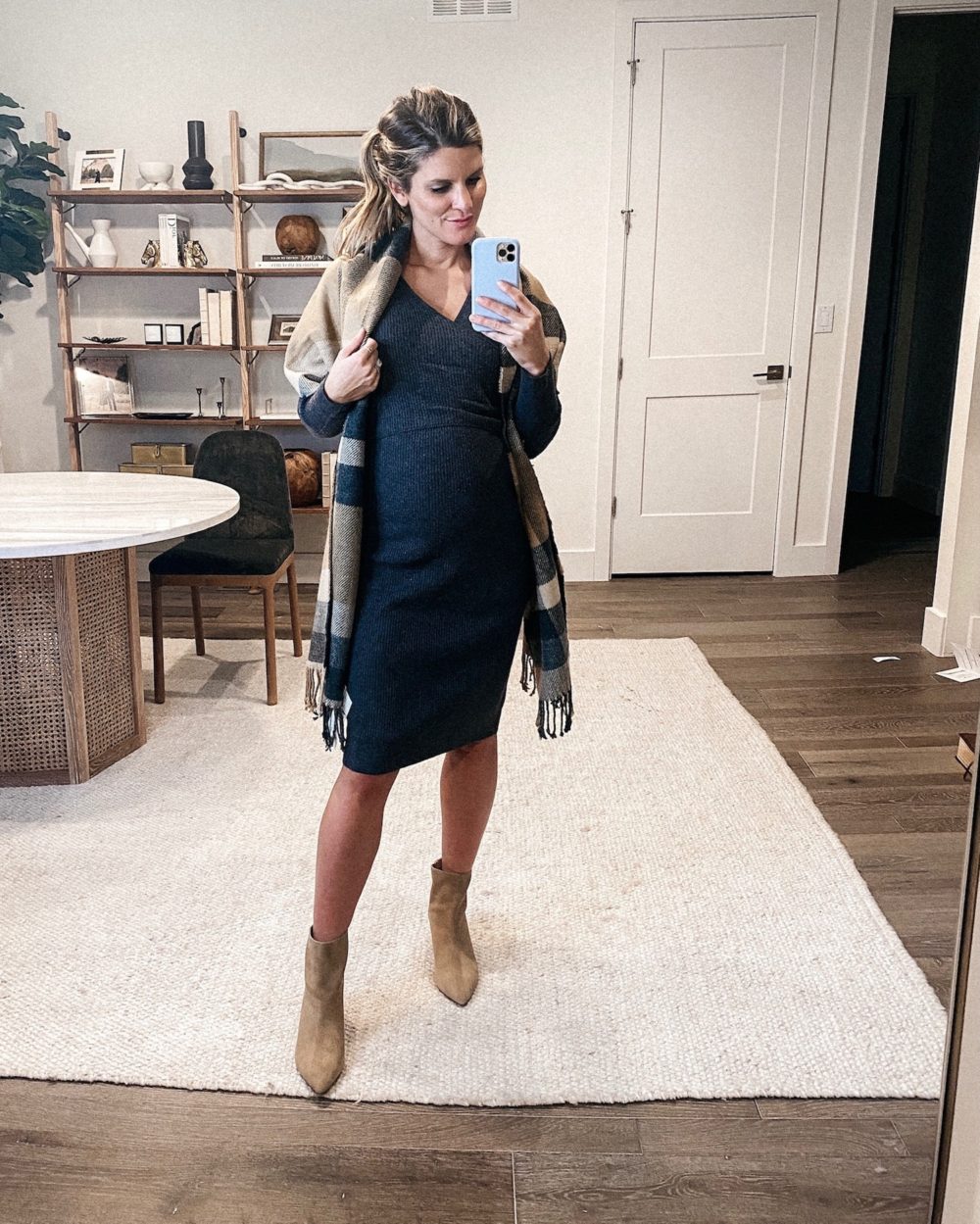 Brighton Butler wearing a grey sweater dress, check scarf and tan booties, pregnancy style