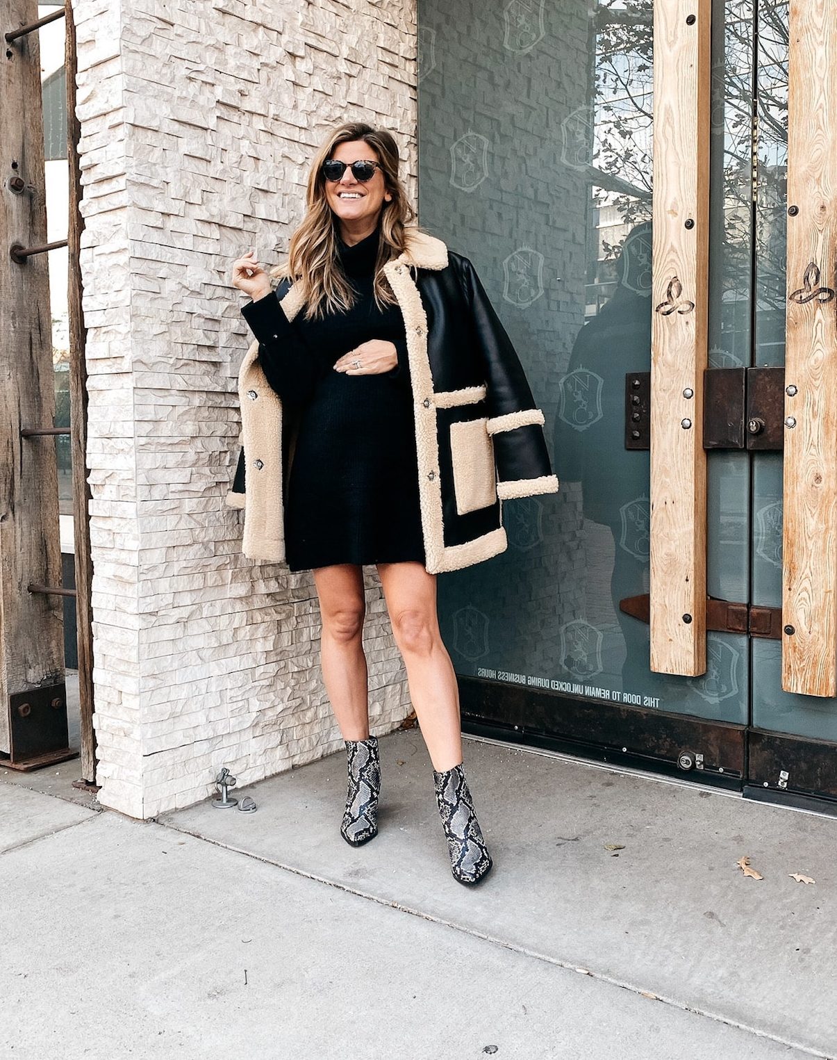 Brighton Butler wearing black leather and fur coat with topshop black dress and snakeskin booties
