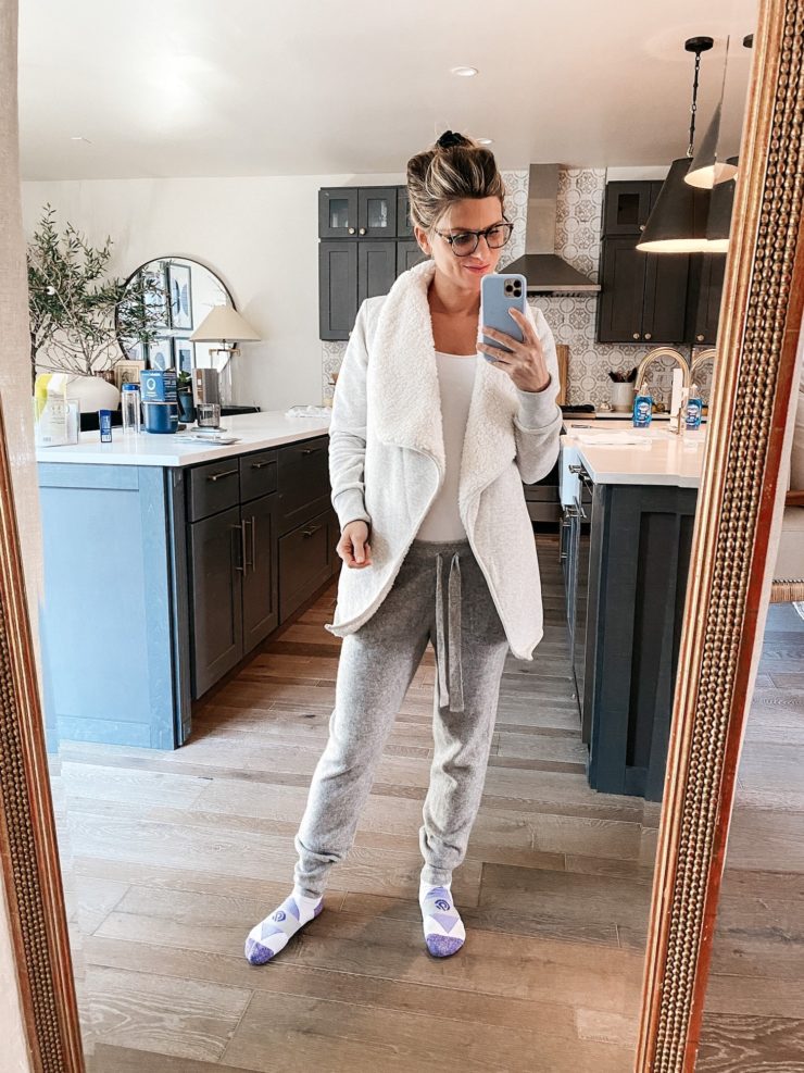 Brighton Butler wearing cozy cardigan, white camisole and grey sweatpants