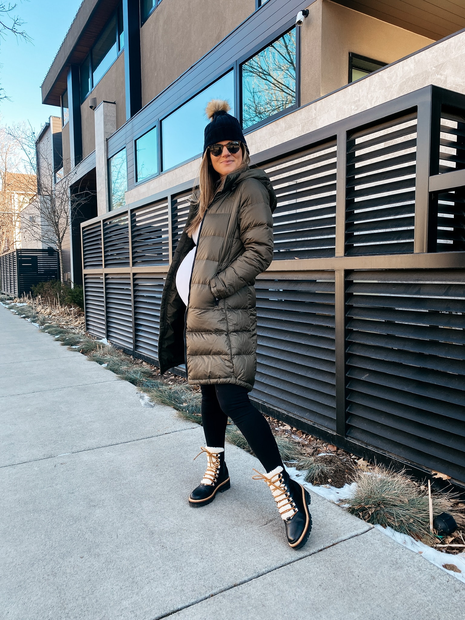 Brighton Butler wearing north face jacket, mar fisher boots, maternity leggings and amazon white shirt