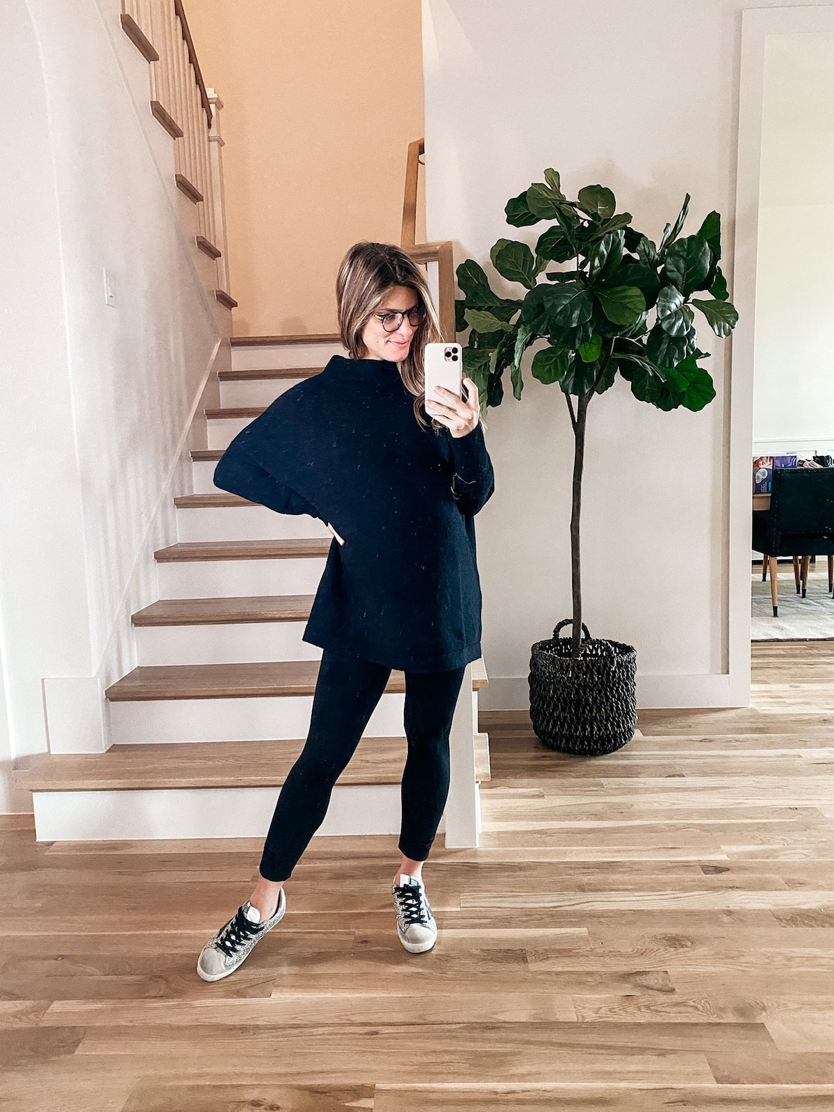 Brighton Butler wearing Amazon sweater with maternity leggings and Golden Goose sneakers