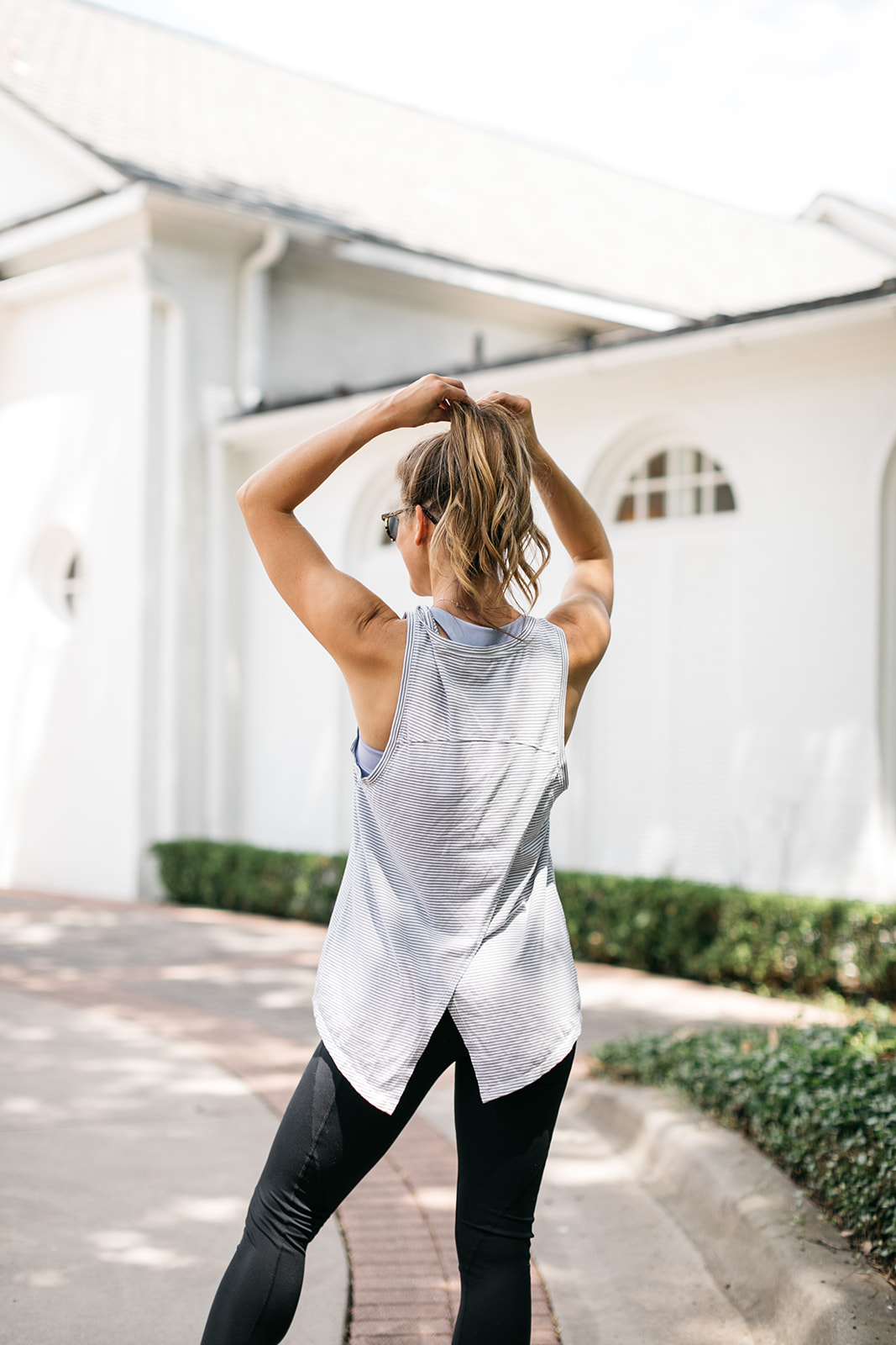 brighton butler wearing nordstrom athleisure white and grey tank with black leggings