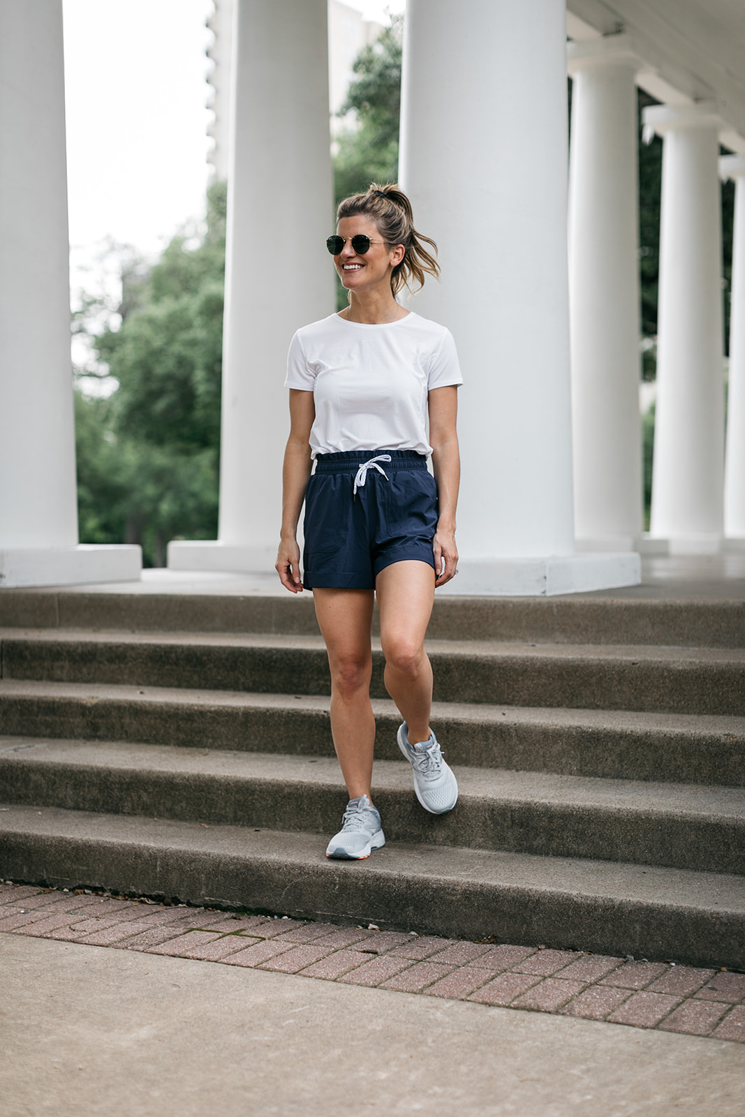 brighton butler wearing nordstrom athleisure blue shorts and white tee