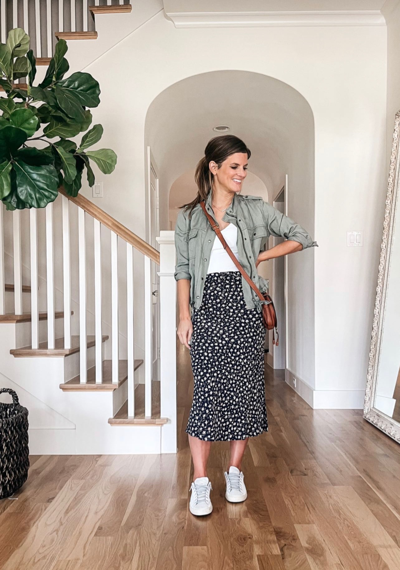 Brighton Butler wearing maxi skirt, army green jacket and bodysuit