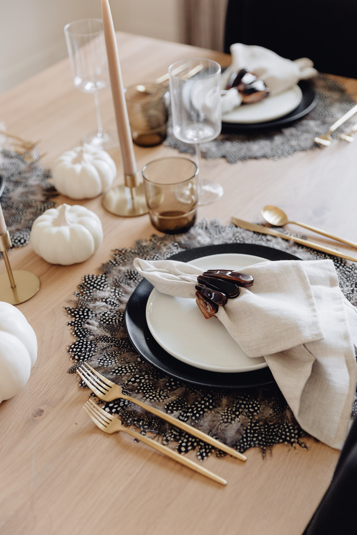brighton butler fall table setting inspiration, black and white place setting with taupe candles and gold candlesticks, gold silverware amazon