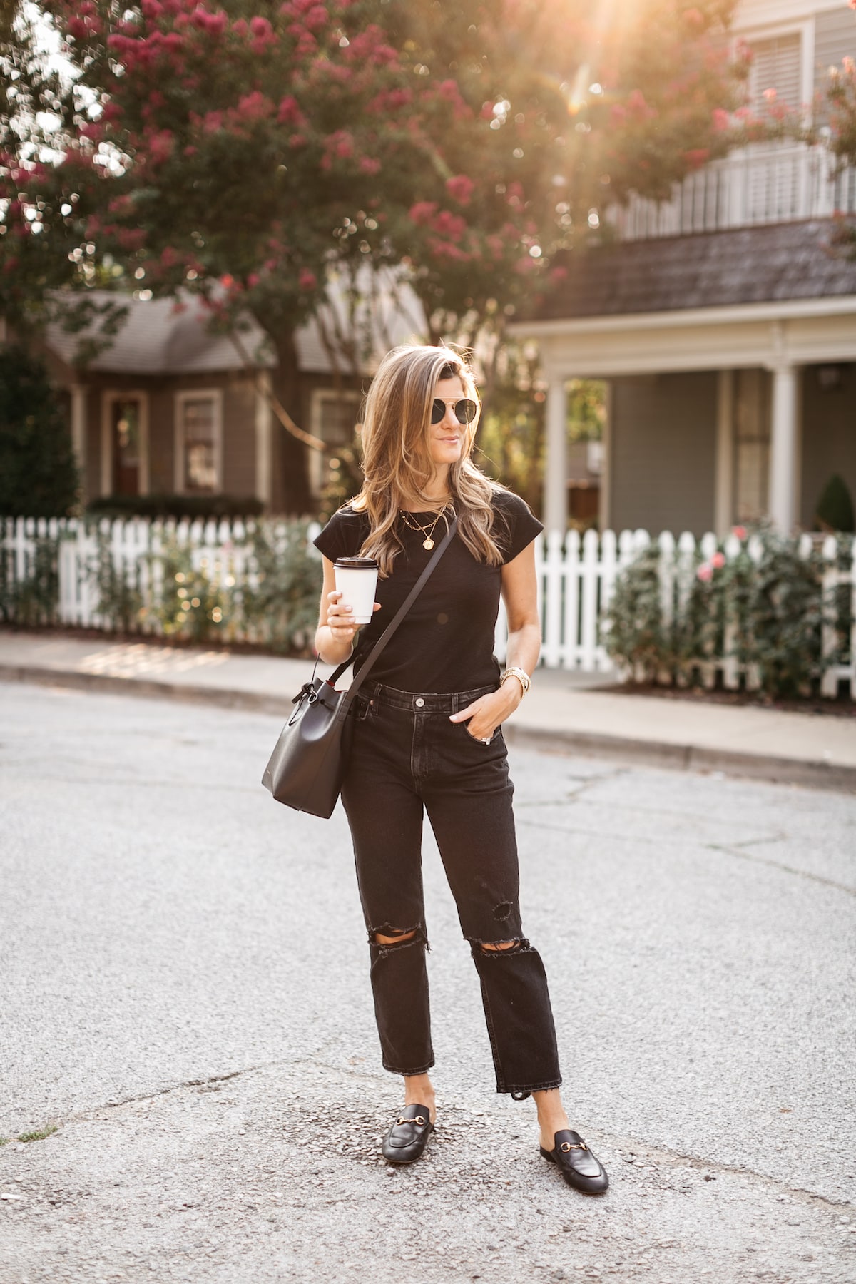 Brighton Butler wearing black tee with black jeans and black bucket bag