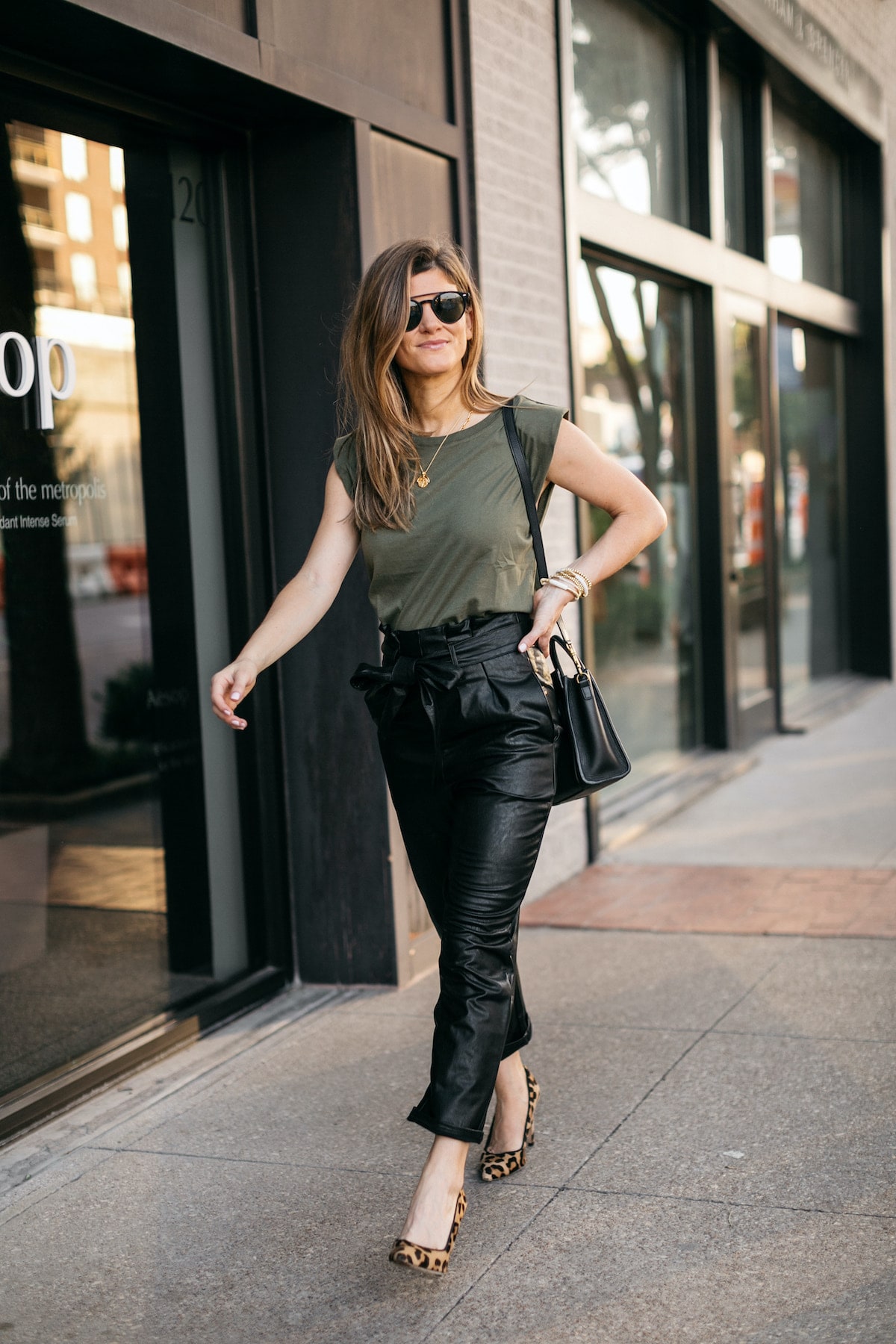 Brighton Butler wearing evereve leather pants with green padded tee and leopard heels