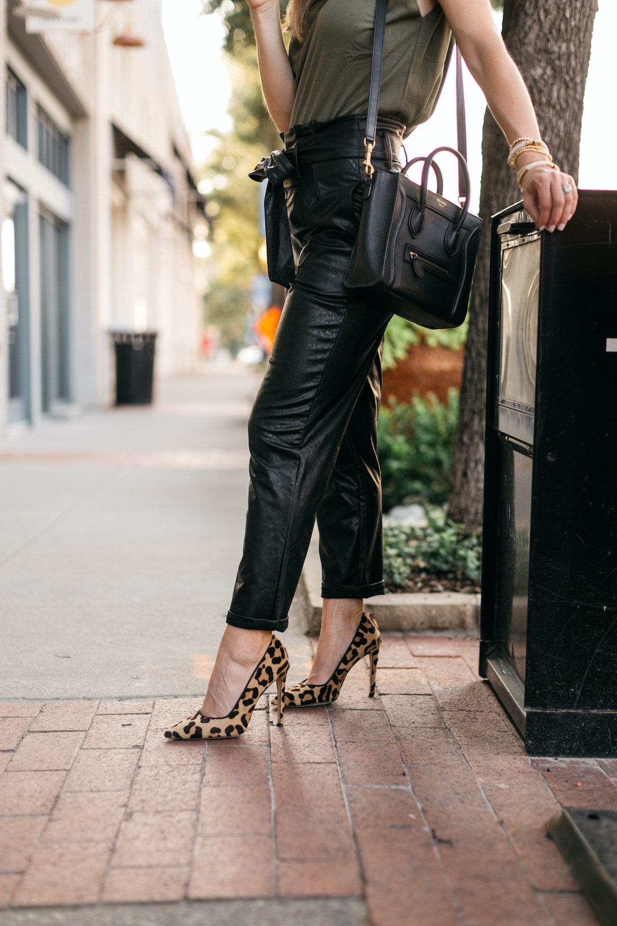 Brighton Butler wearing evereve leather pants with green padded tee and leopard heels