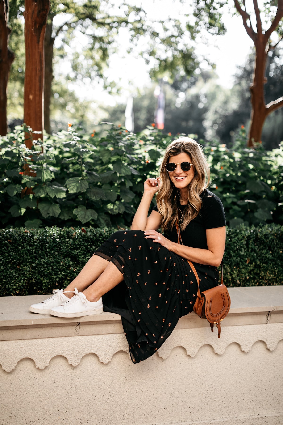 Brighton Butler wearing Madewell Fall Floral Skirt with Black tee and Frye white sneakers