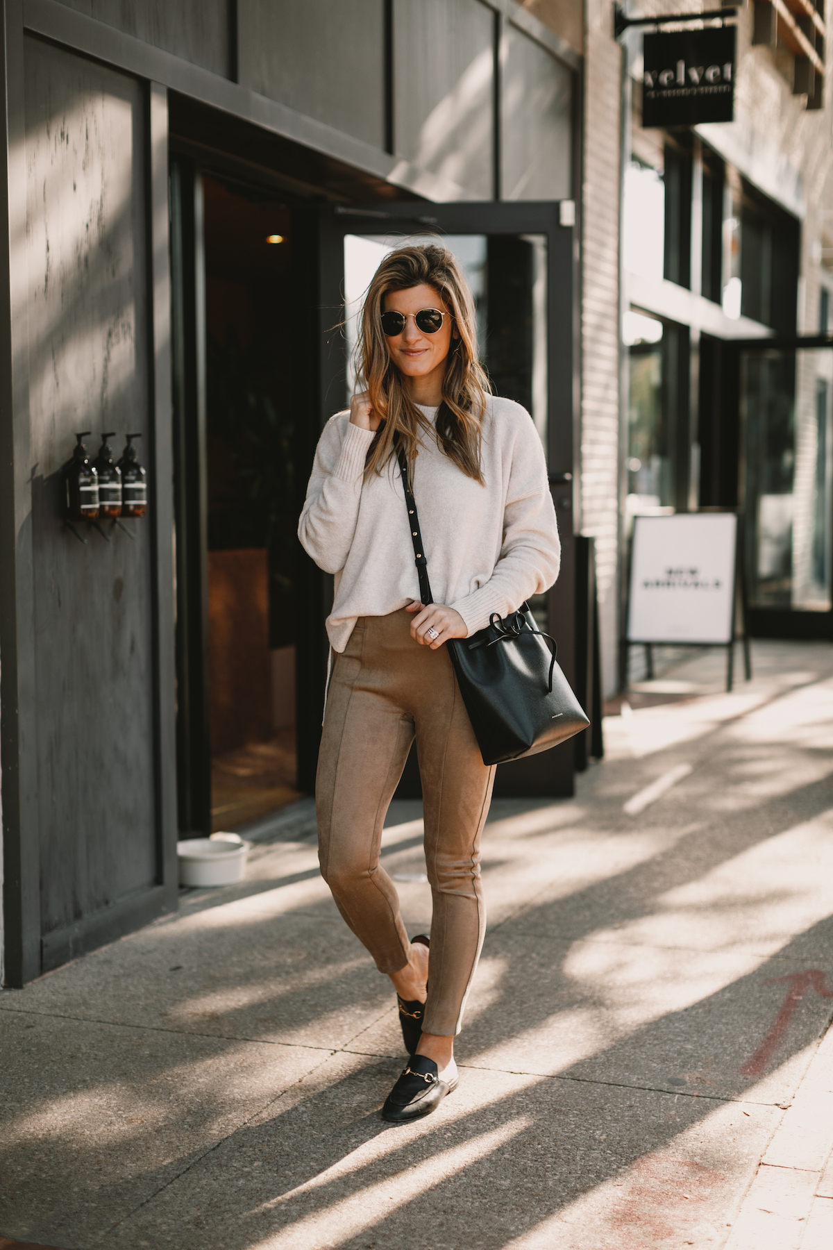 Brighton Butler wearing Spanx Suede Leggings with Sweater and Gucci Slides