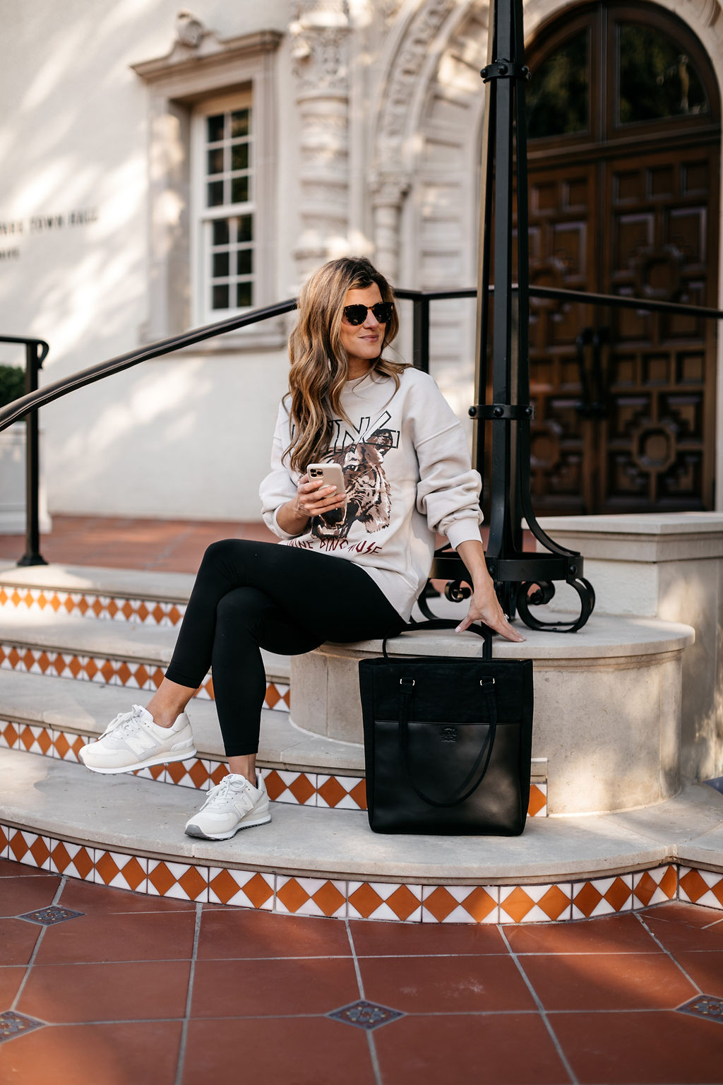 athleisure outfit graphic sweatshirt, black leggings, new balance sneakers, computer bag 15