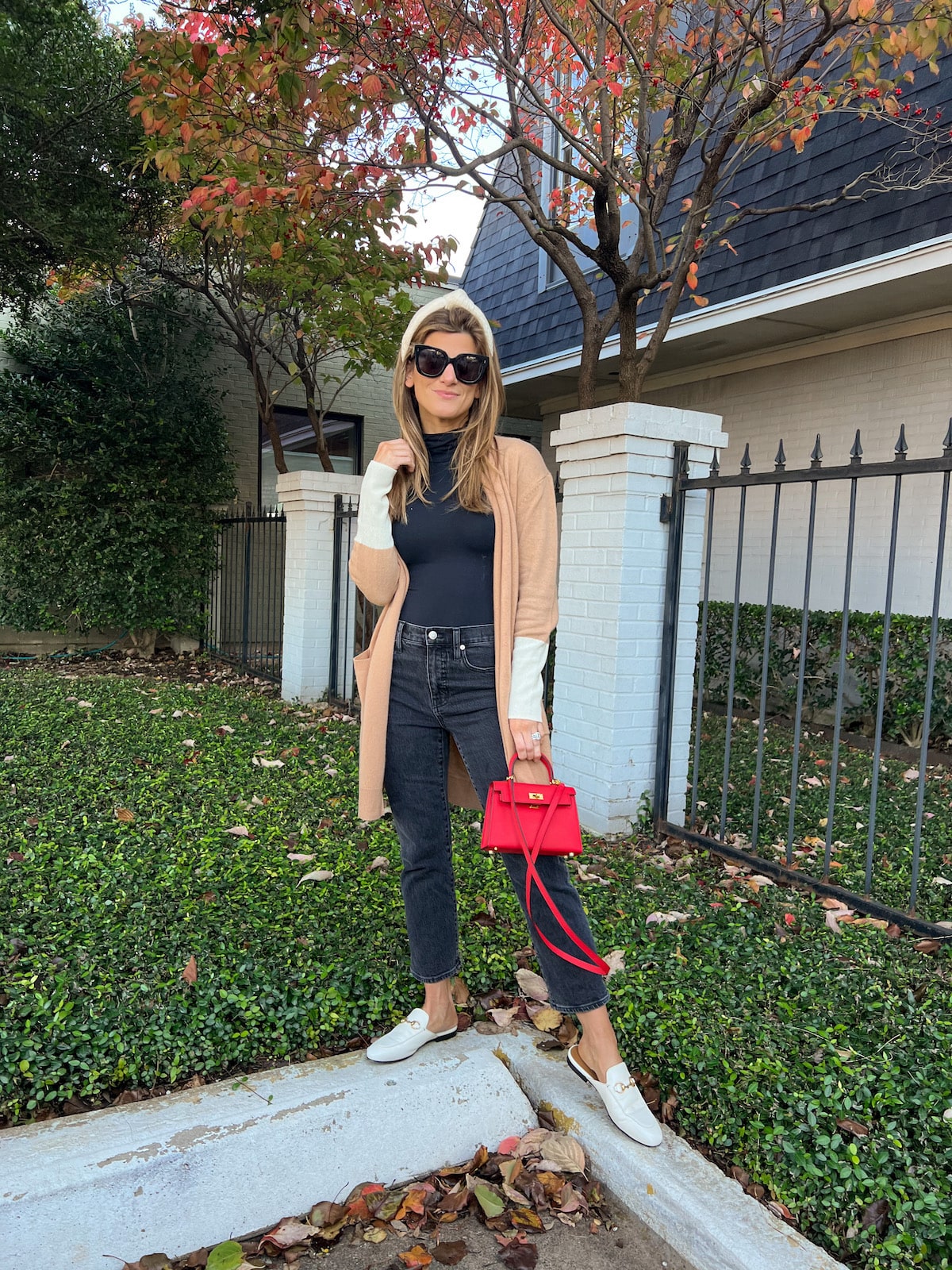 Brighton Butler wearing ParrishLA colorblock cardigan with madewell black jeans and red bag
