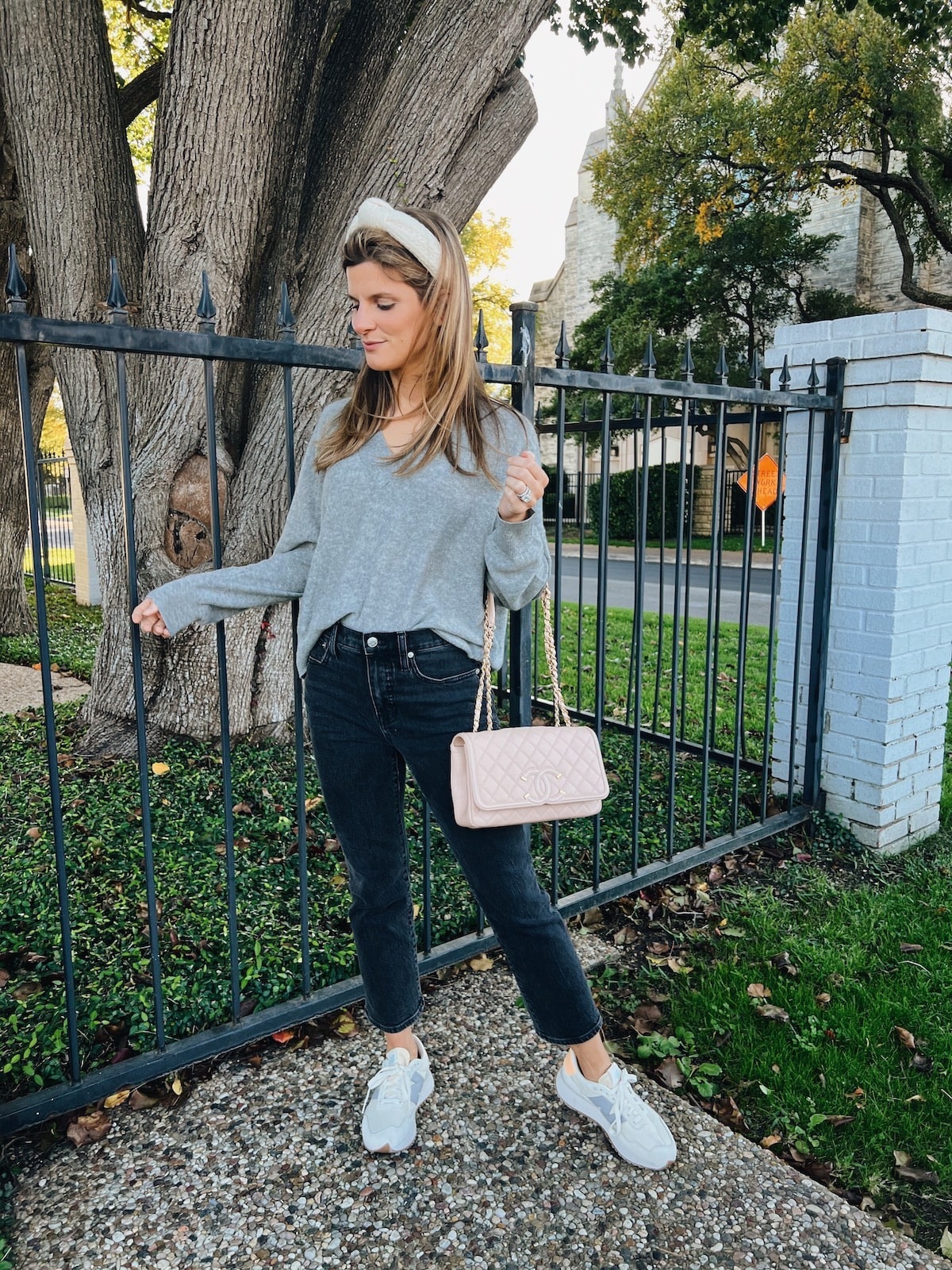 Brighton Butler wearing ParrishLA grey sweater and madewell jeans with new balance sneakers