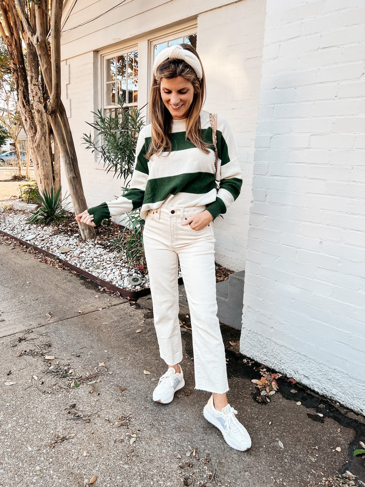 Brighton Butler wearing ParrishLA striped sweater with cream madewell jeans and new balance sneakers