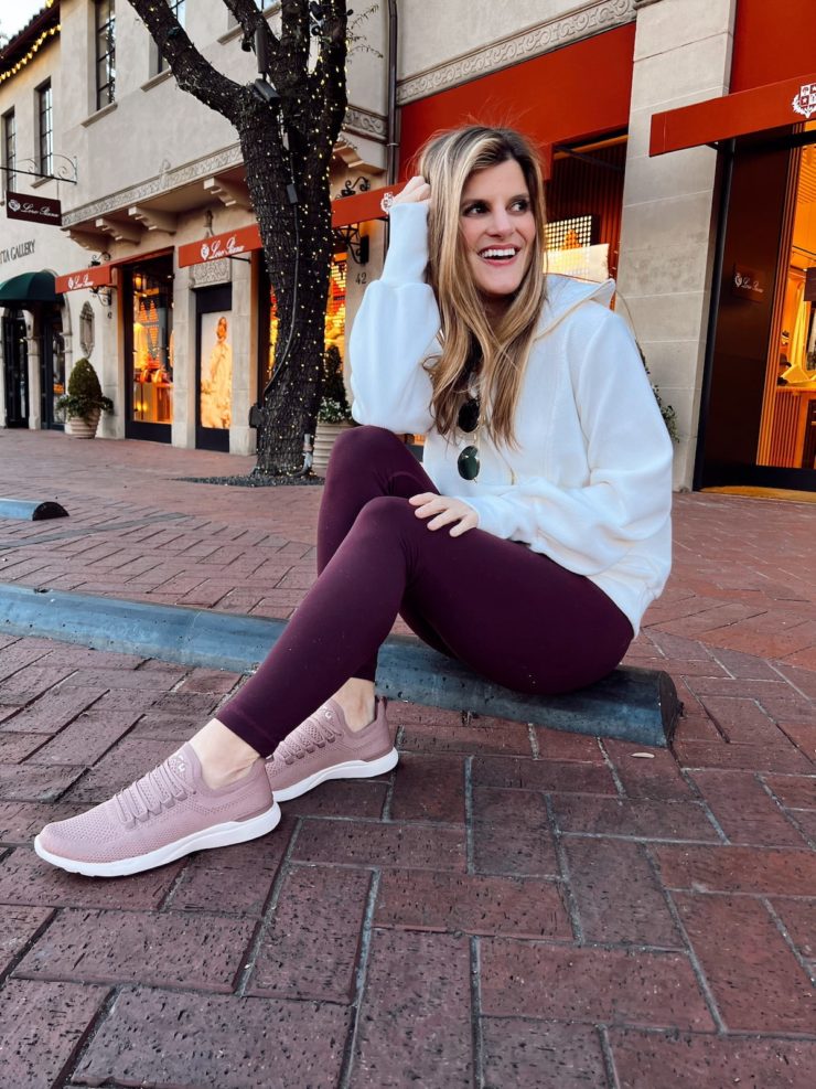 Brighton Butler wearing Varley pullover with maroon lulu aligns and APL's
