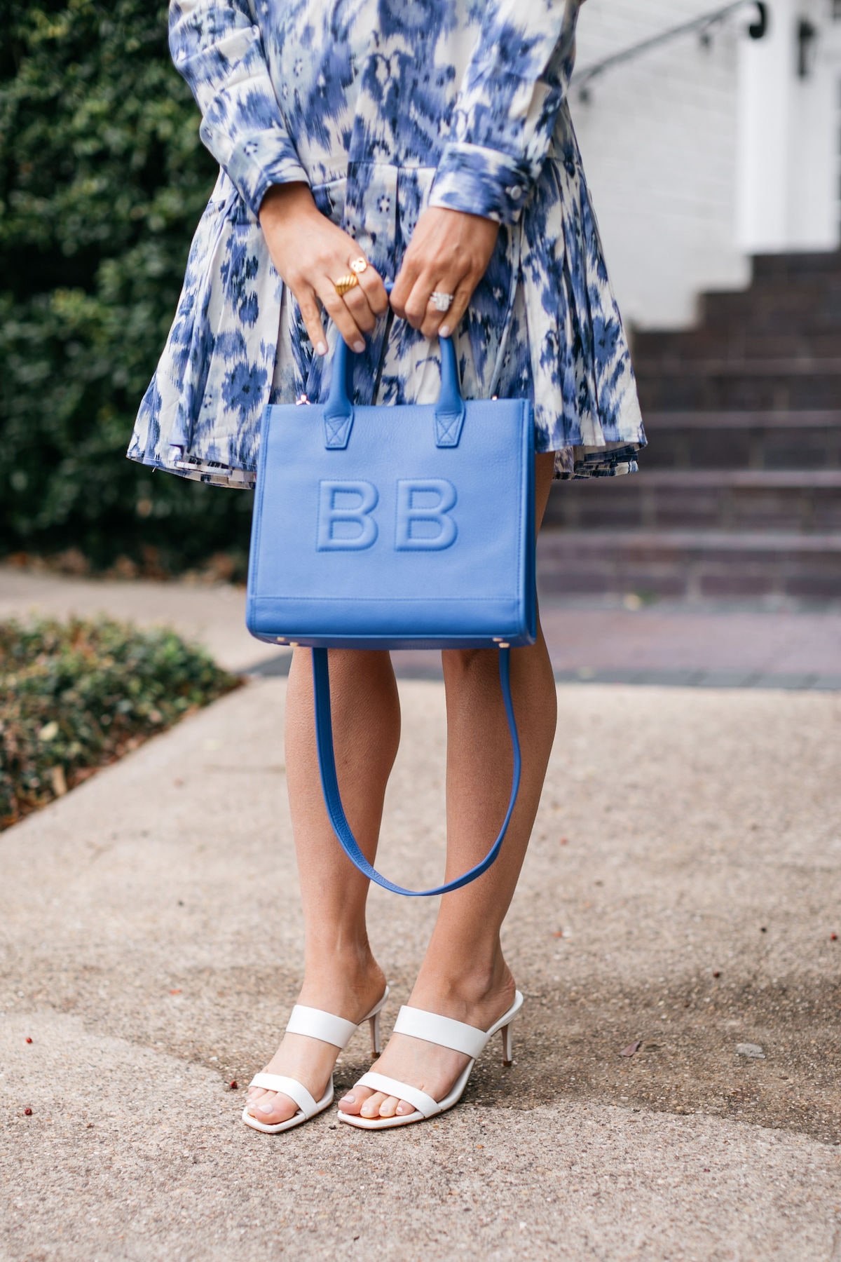 Brighont Butler wearing blue leatherology bag with blue tuckernuck dress