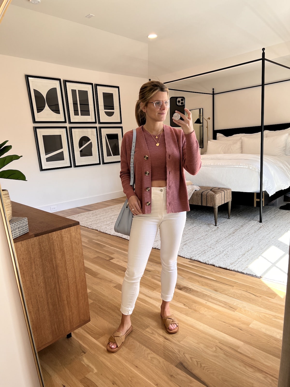 Brighton Butler wearing madewell white jeans and pink cardigan set