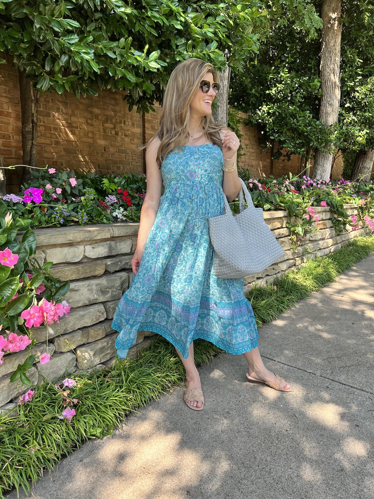 Brighton Butler wearing revolve blue floral dress with blue beach bag