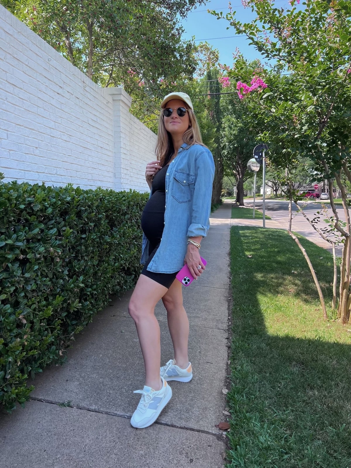 Brighton Butler wearing beyond yoga unitard with chambray and yellow dad hat