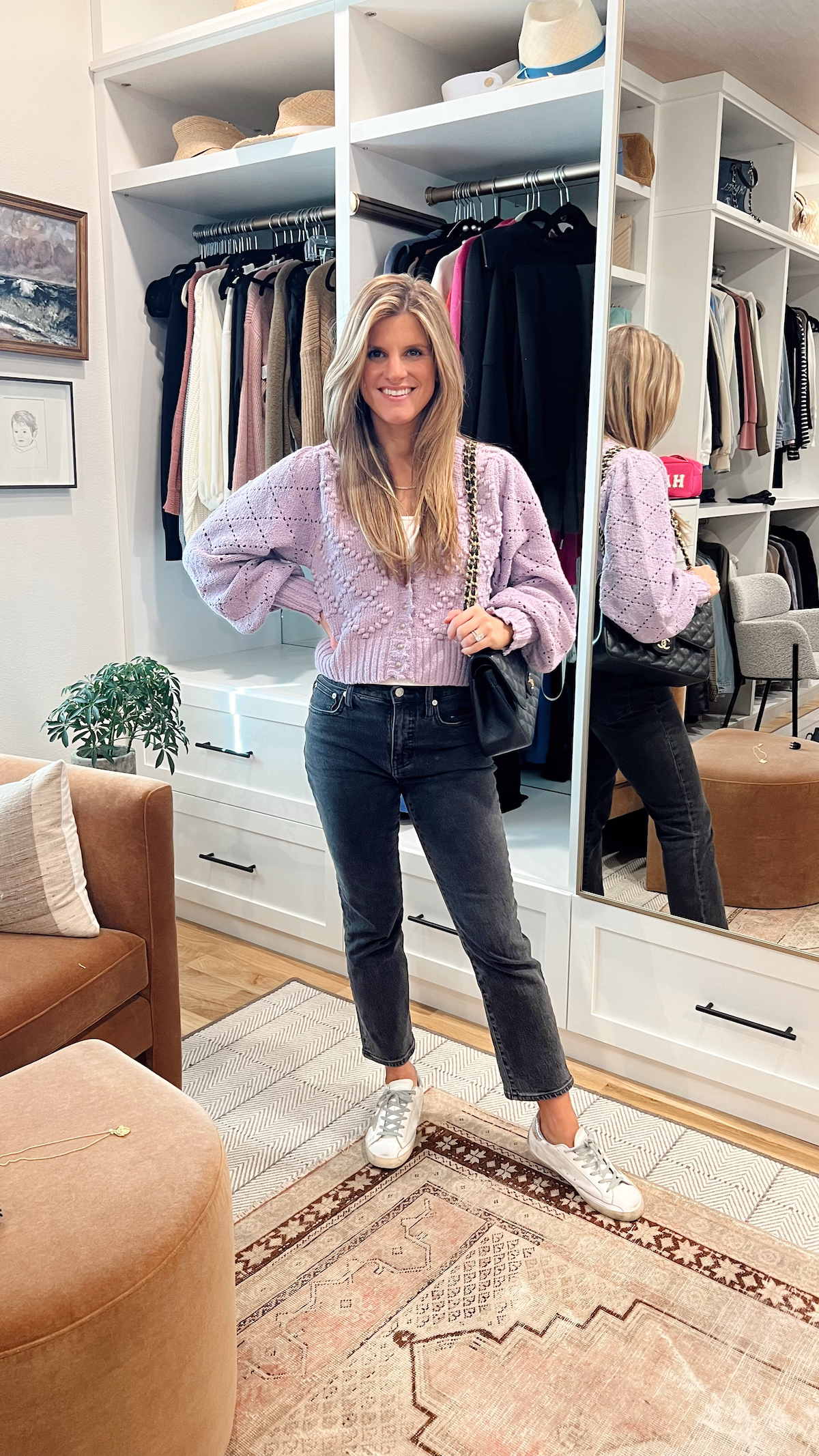 Brighton Butler wearing madewell flare jeans with purple cardigan